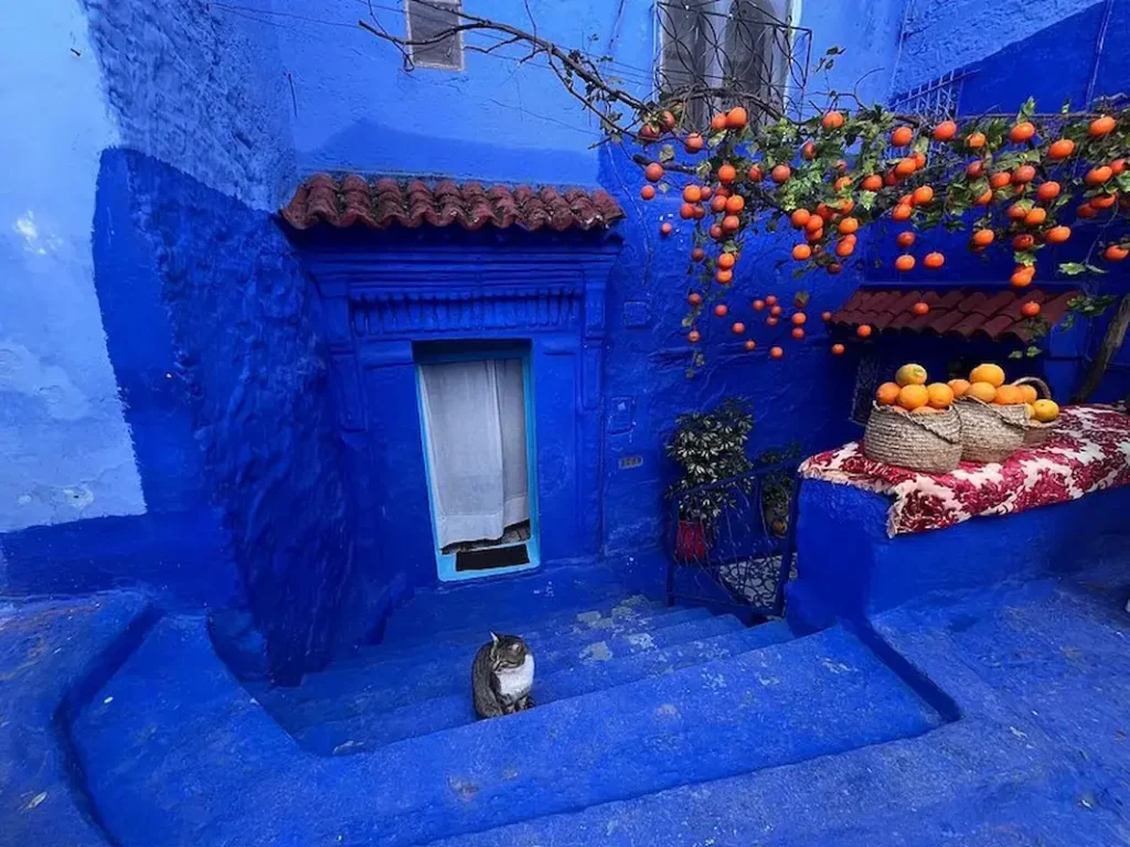 Narrow, blue-painted streets in Chefchaouen Morocco with traditional houses and vibrant decorative details